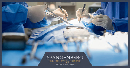 two surgeons operating on a patient